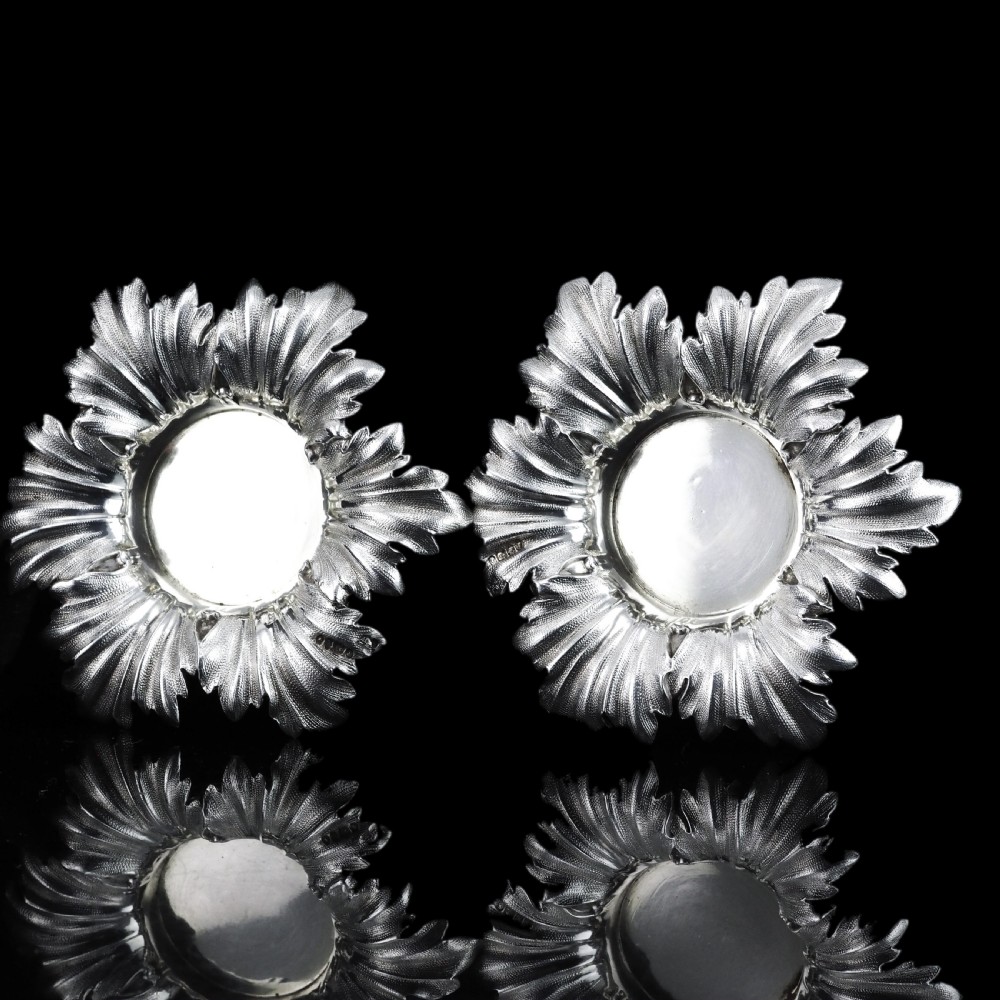 Pair of Victorian sterling silver open salt dishes featuring detailed chased leaf motifs radiating around a central polished circular well. View XI