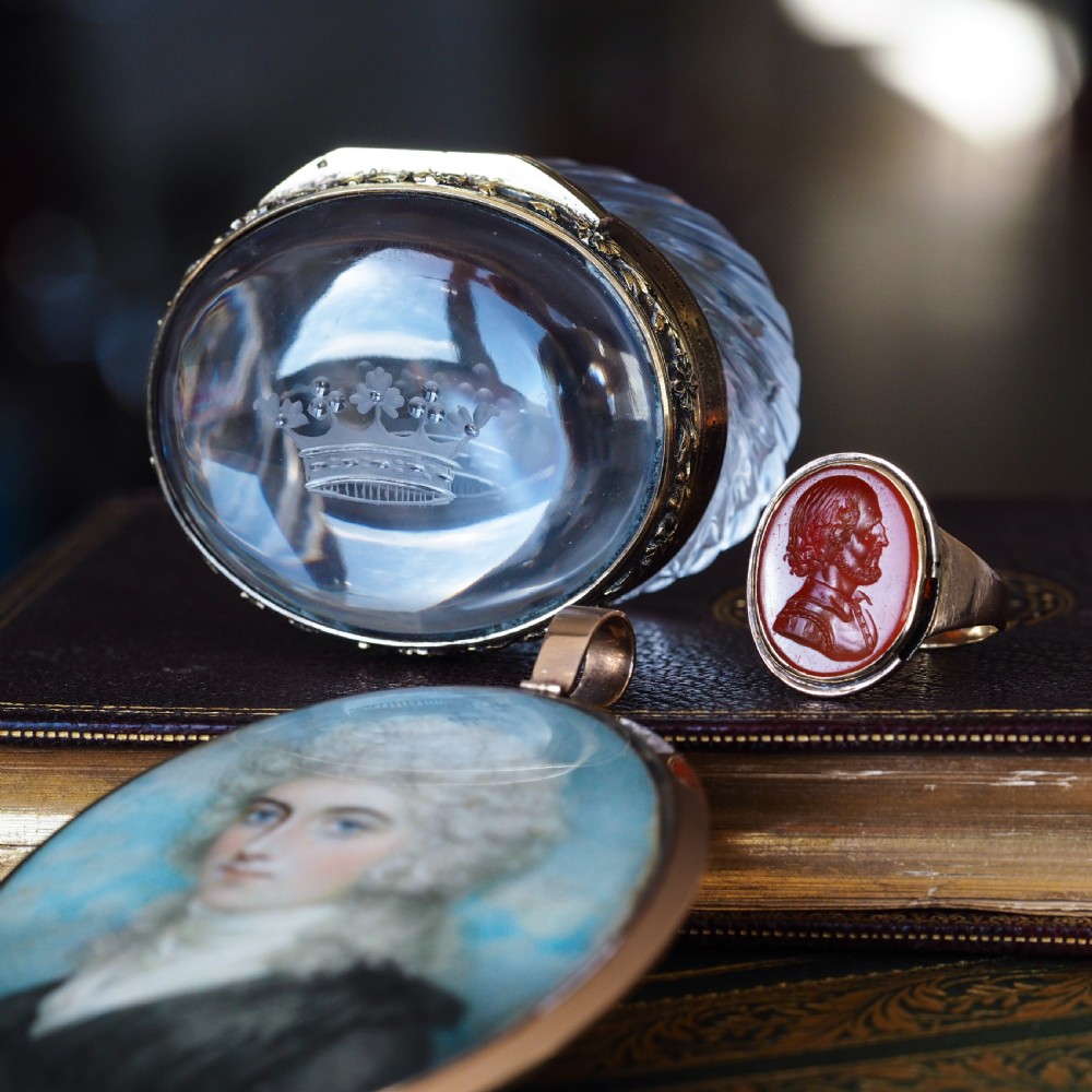 An antique gold signet ring featuring an oval red carnelian gemstone carved with the side profile portrait of a gentleman. View XI