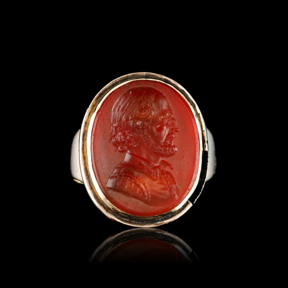 An antique gold signet ring featuring an oval red carnelian gemstone carved with the side profile portrait of a gentleman. View XVIII