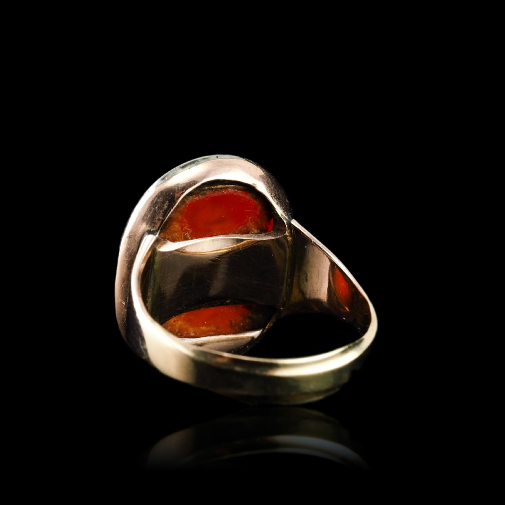 An antique gold signet ring featuring an oval red carnelian gemstone carved with the side profile portrait of a gentleman. View XXI