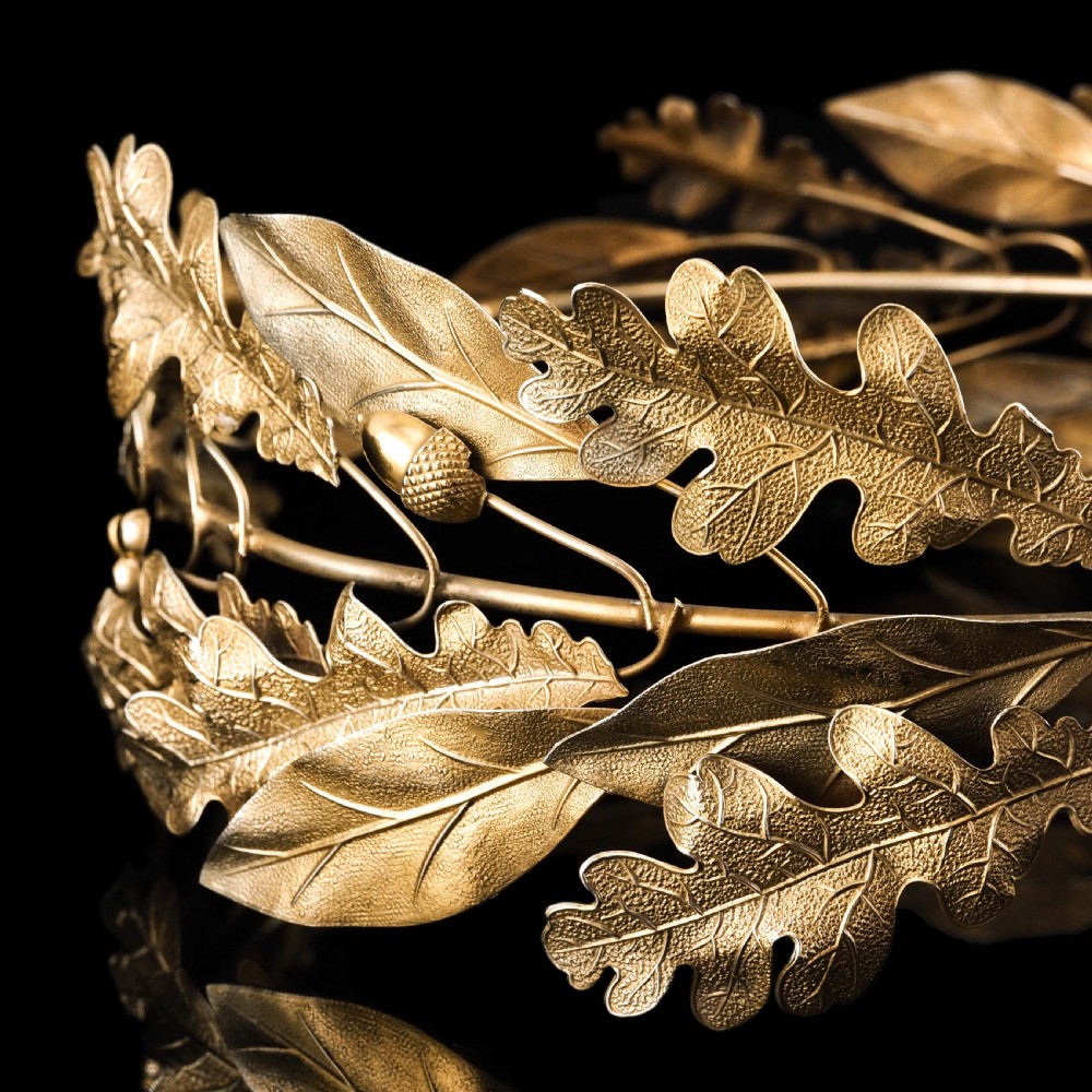 A 19th-century silver gilt foliate crown featuring detailed oak leaves, acorns, laurel leaves, and a central ribbon bow medallion. View XIV