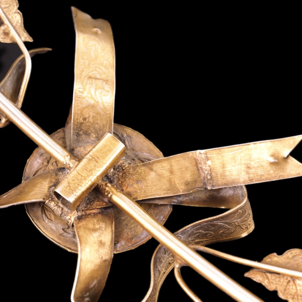 A 19th-century silver gilt foliate crown featuring detailed oak leaves, acorns, laurel leaves, and a central ribbon bow medallion. View XIX