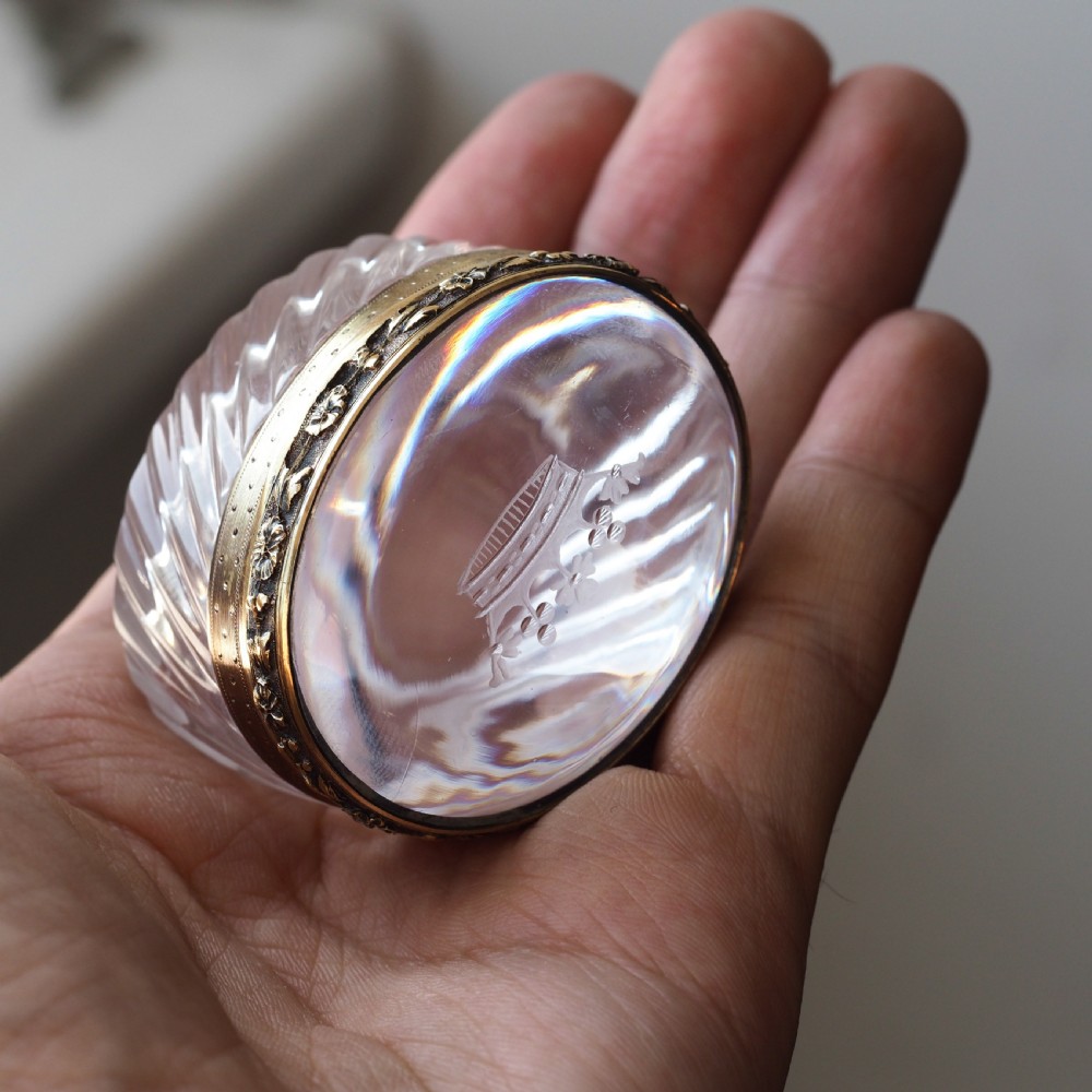 An oval cut crystal box featuring a gilt silver rim and a transparent glass lid etched with a nobility coronet crest. View VII