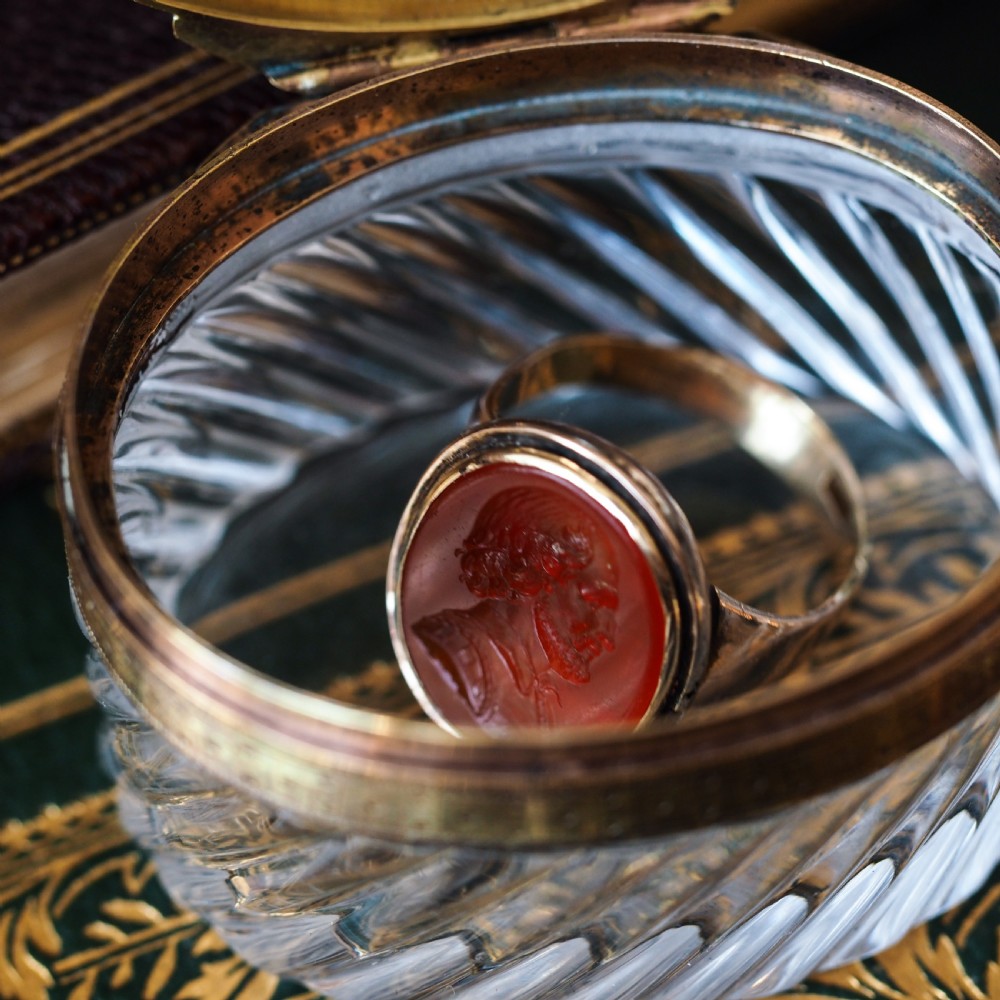 An oval cut crystal box featuring a gilt silver rim and a transparent glass lid etched with a nobility coronet crest. View IX