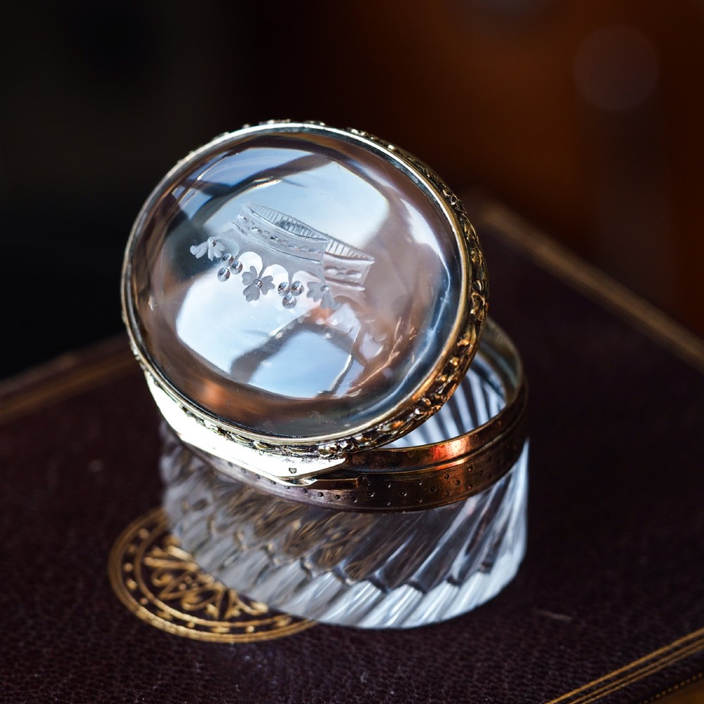 An oval cut crystal box featuring a gilt silver rim and a transparent glass lid etched with a nobility coronet crest. View XI