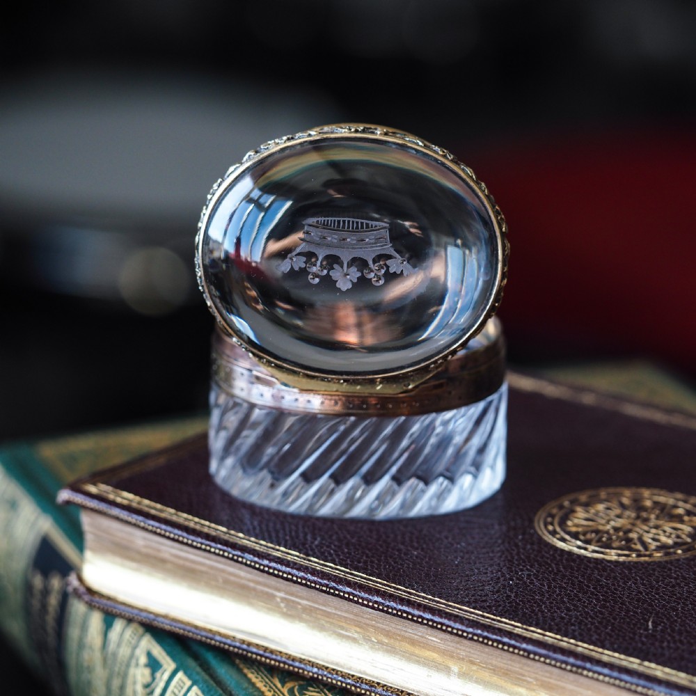 An oval cut crystal box featuring a gilt silver rim and a transparent glass lid etched with a nobility coronet crest. View XII