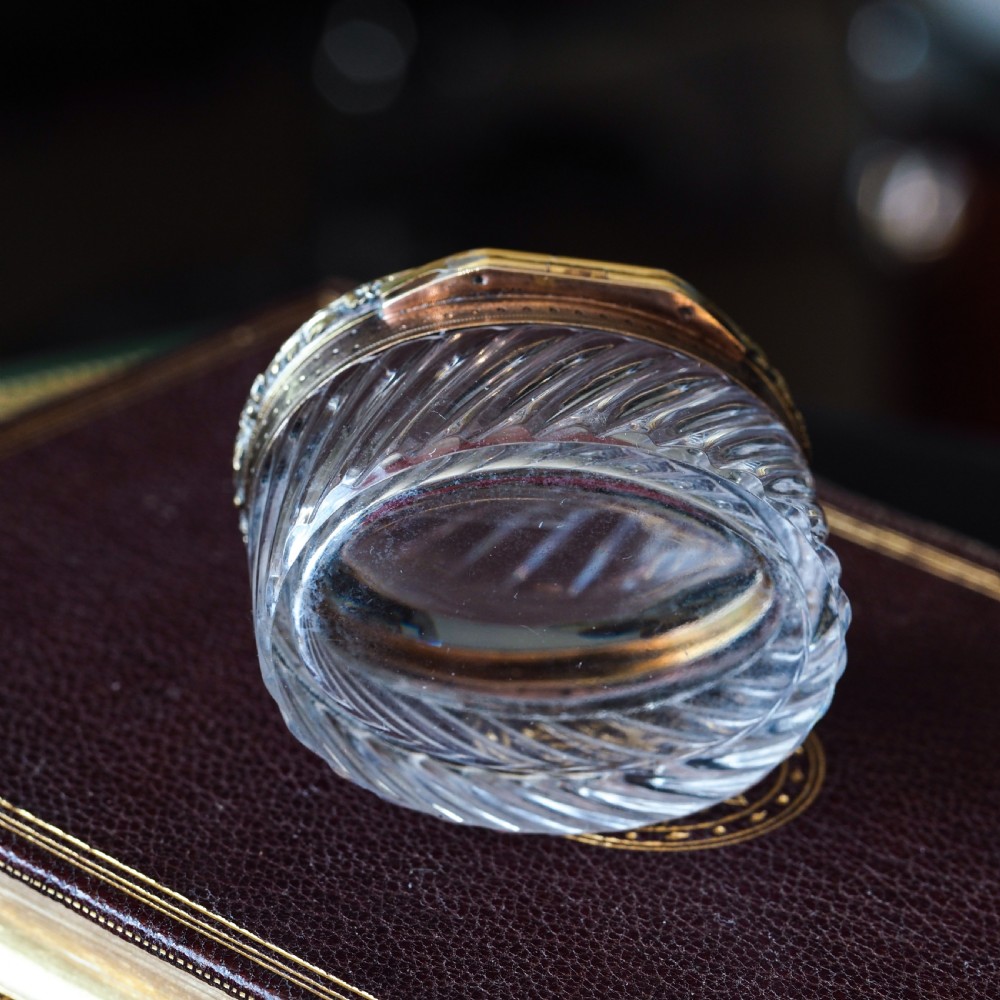 An oval cut crystal box featuring a gilt silver rim and a transparent glass lid etched with a nobility coronet crest. View XIII
