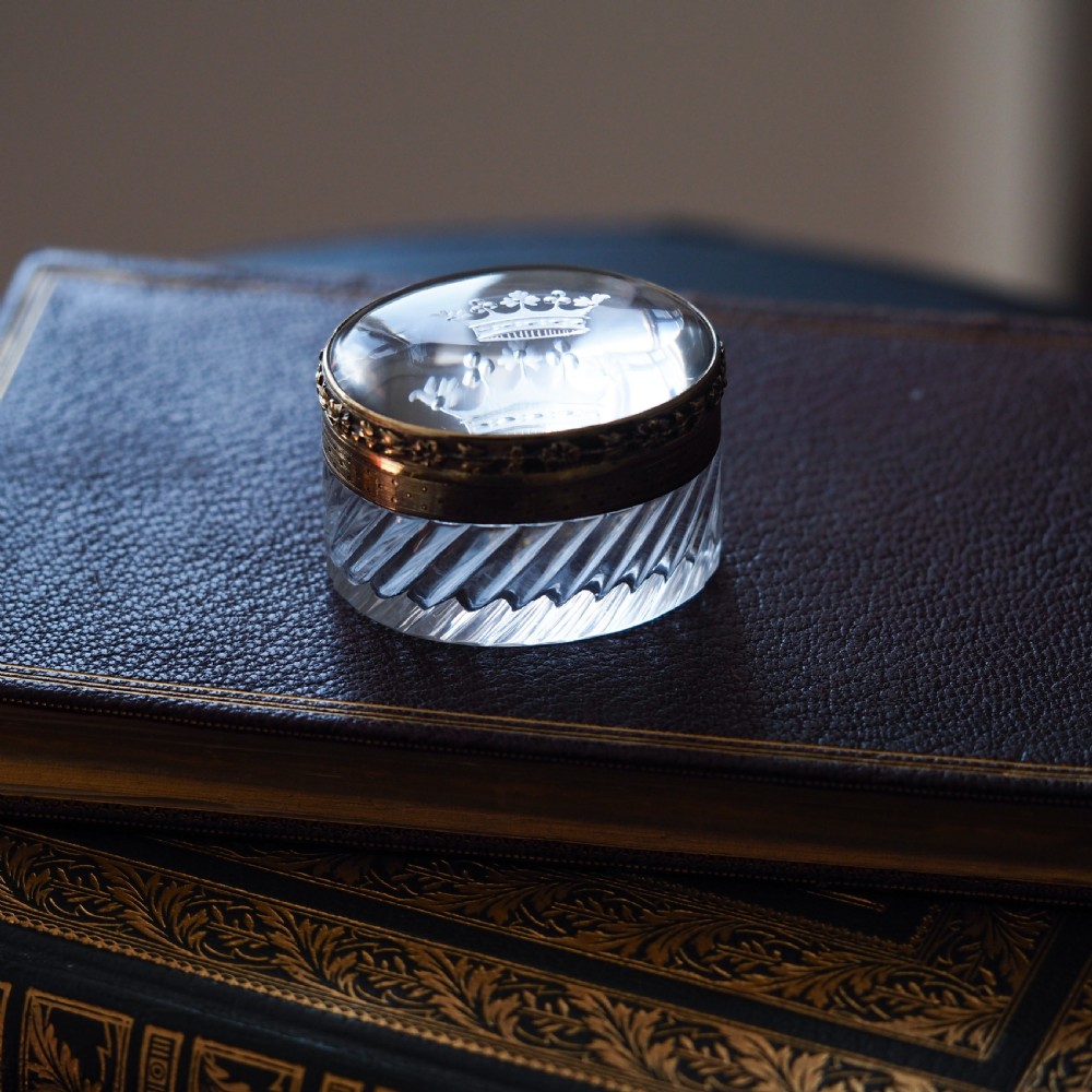 An oval cut crystal box featuring a gilt silver rim and a transparent glass lid etched with a nobility coronet crest. View XVII