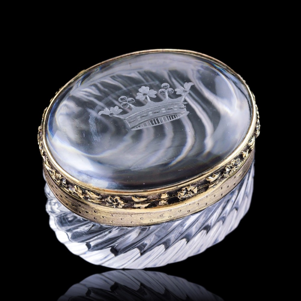 An oval cut crystal box featuring a gilt silver rim and a transparent glass lid etched with a nobility coronet crest. View XIX