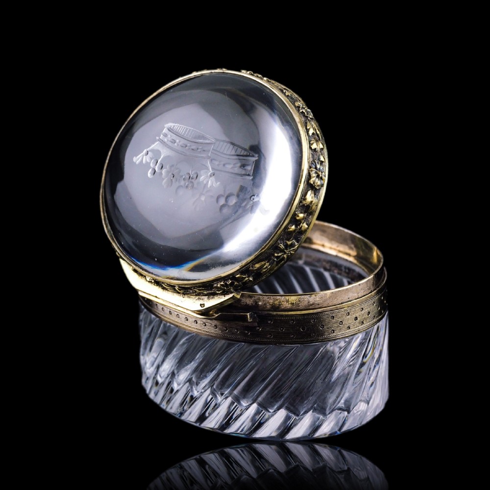 An oval cut crystal box featuring a gilt silver rim and a transparent glass lid etched with a nobility coronet crest. View XXI