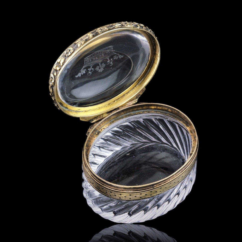 An oval cut crystal box featuring a gilt silver rim and a transparent glass lid etched with a nobility coronet crest. View XXII