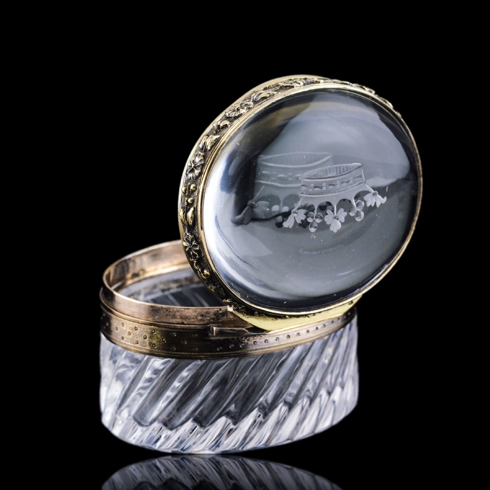 An oval cut crystal box featuring a gilt silver rim and a transparent glass lid etched with a nobility coronet crest. View XXIII