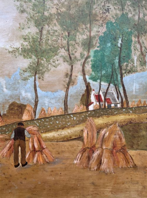 fig 5. A mid-20th-century naive oil painting depicting agricultural workers gathering hay bales in a field beside a timber windmill, thatched cottages, and trees, presented in a gilt frame.
