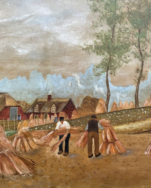 fig 6. A mid-20th-century naive oil painting depicting agricultural workers gathering hay bales in a field beside a timber windmill, thatched cottages, and trees, presented in a gilt frame.