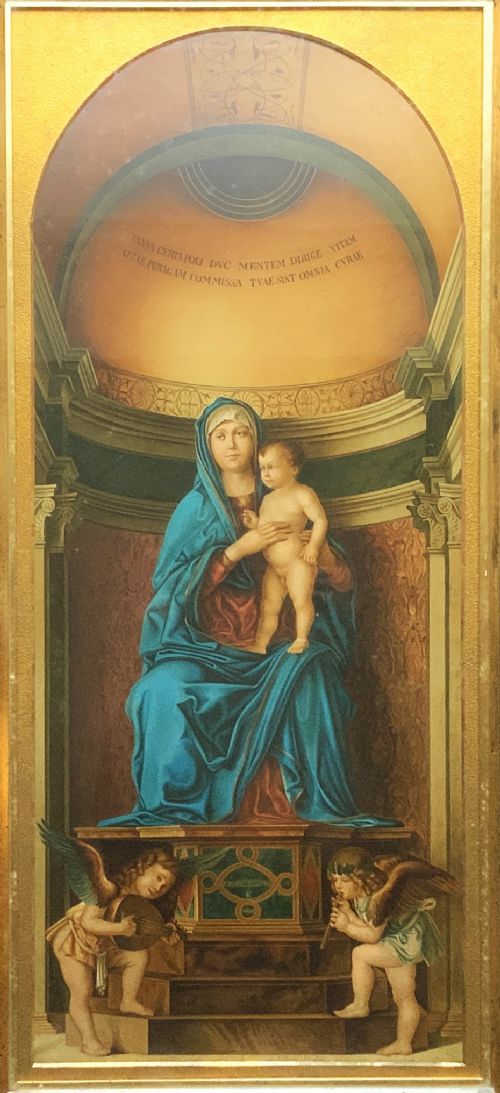 fig 1. A framed antique religious art print depicting the Madonna and Child within a gilt arched alcove above two musical cherubs, set in a dark moulded frame.