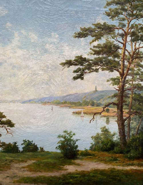 fig 2. A signed 20th-century oil painting depicting a calm lake with sailboats framed by birch and pine trees in a silvered wooden frame.