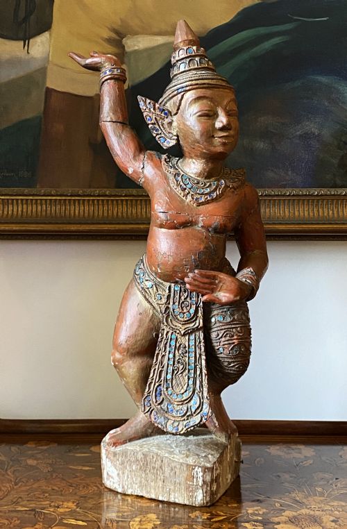 fig 1. A pair of 19th-century carved wooden Burmese Nat statues featuring a red painted finish, elaborate crowns, and glass mirror inlays.