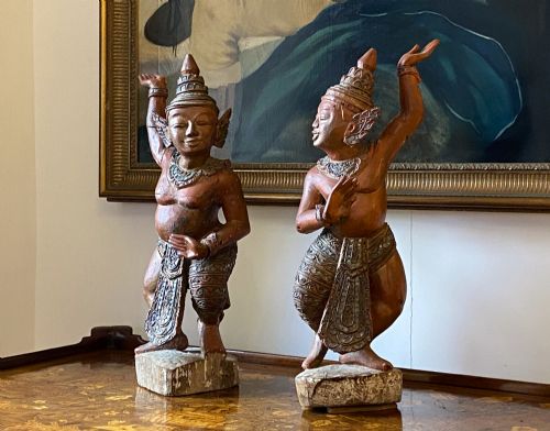 fig 3. A pair of 19th-century carved wooden Burmese Nat statues featuring a red painted finish, elaborate crowns, and glass mirror inlays.