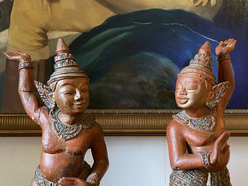 fig 4. A pair of 19th-century carved wooden Burmese Nat statues featuring a red painted finish, elaborate crowns, and glass mirror inlays.