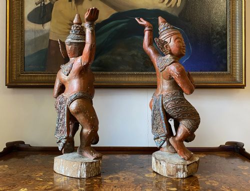 fig 5. A pair of 19th-century carved wooden Burmese Nat statues featuring a red painted finish, elaborate crowns, and glass mirror inlays.