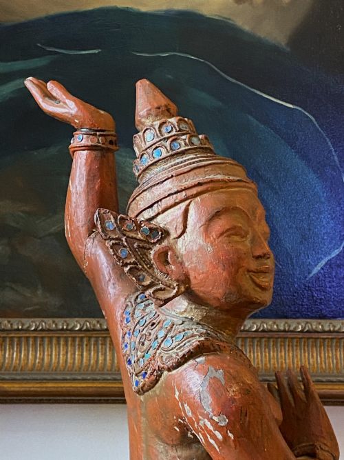 fig 6. A pair of 19th-century carved wooden Burmese Nat statues featuring a red painted finish, elaborate crowns, and glass mirror inlays.