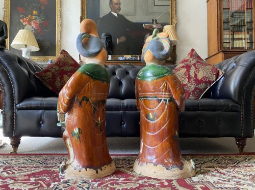 fig 5. A pair of large Sancai glazed ceramic sculptures depicting Tang Dynasty style female court musicians in orange, green, and cream robes.
