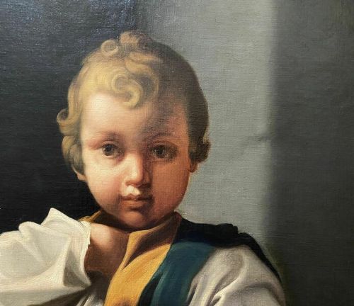 fig 2. An eighteenth-century Baroque style oil painting on canvas depicting a standing young child dressed in a white tunic and green vest, set within a carved gilt frame.