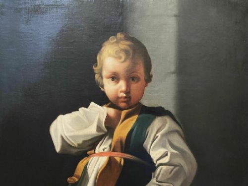 fig 5. An eighteenth-century Baroque style oil painting on canvas depicting a standing young child dressed in a white tunic and green vest, set within a carved gilt frame.