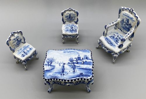 fig 1. A four-piece set of miniature ceramic furniture decorated with hand-painted blue and white Dutch landscapes and windmill scenes.