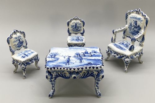 fig 2. A four-piece set of miniature ceramic furniture decorated with hand-painted blue and white Dutch landscapes and windmill scenes.