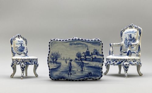 fig 4. A four-piece set of miniature ceramic furniture decorated with hand-painted blue and white Dutch landscapes and windmill scenes.