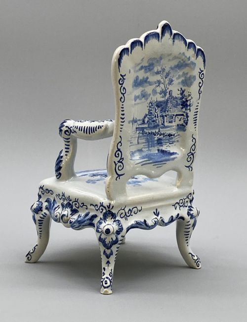 fig 6. A four-piece set of miniature ceramic furniture decorated with hand-painted blue and white Dutch landscapes and windmill scenes.