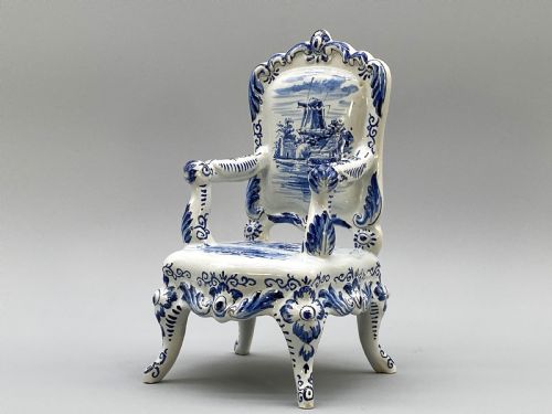 fig 7. A four-piece set of miniature ceramic furniture decorated with hand-painted blue and white Dutch landscapes and windmill scenes.