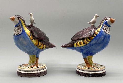 fig 1. A pair of 18th-century Spanish tin-glazed faience tureens fashioned as partridges with hand-painted blue, yellow, and brown plumage and small bird finials on their removable covers.
