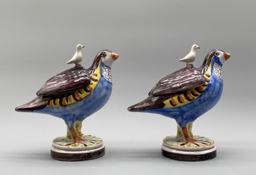 fig 3. A pair of 18th-century Spanish tin-glazed faience tureens fashioned as partridges with hand-painted blue, yellow, and brown plumage and small bird finials on their removable covers.