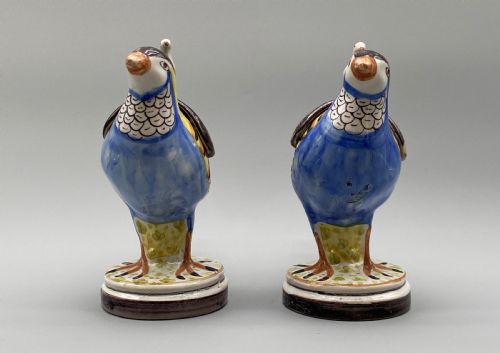 fig 5. A pair of 18th-century Spanish tin-glazed faience tureens fashioned as partridges with hand-painted blue, yellow, and brown plumage and small bird finials on their removable covers.