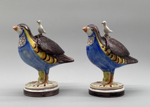 fig 6. A pair of 18th-century Spanish tin-glazed faience tureens fashioned as partridges with hand-painted blue, yellow, and brown plumage and small bird finials on their removable covers.