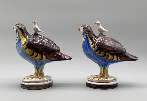 fig 7. A pair of 18th-century Spanish tin-glazed faience tureens fashioned as partridges with hand-painted blue, yellow, and brown plumage and small bird finials on their removable covers.