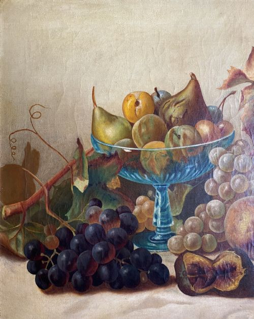 fig 4. An oil painting depicting a still life composition of grapes, pears, peaches, and figs arranged on a draped cloth with a blue glass pedestal dish, enclosed in a moulded gilt frame.