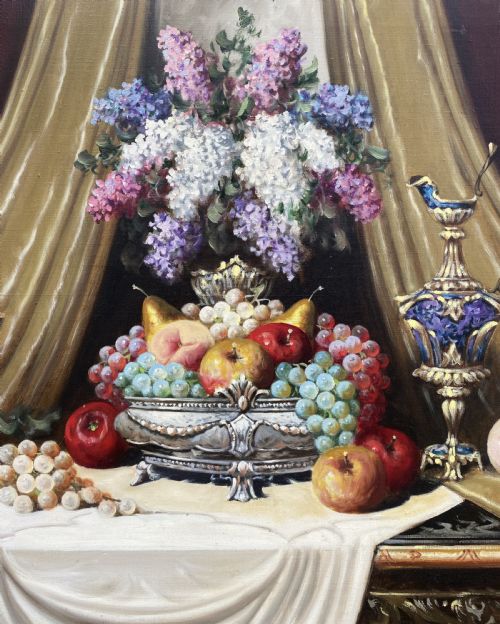 fig 4. A framed oil painting on canvas depicting a table with fruit, lilacs in a central vase, silver ewers, and draped gold and burgundy fabrics.