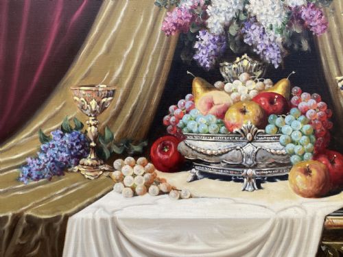 fig 6. A framed oil painting on canvas depicting a table with fruit, lilacs in a central vase, silver ewers, and draped gold and burgundy fabrics.