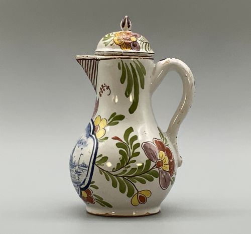 fig 3. An 18th-century Dutch Delft tin-glazed ceramic coffee pot decorated with polychrome floral motifs and a central blue maritime landscape medallion.