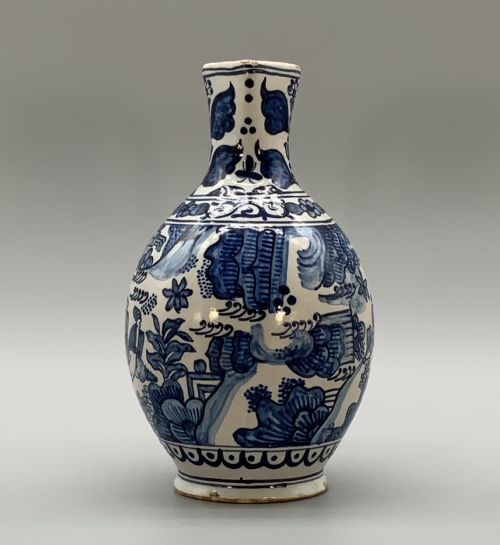 fig 2. An antique Dutch Delftware ceramic jug decorated with cobalt blue hand-painted Chinoiserie figures and botanical motifs against a white tin glaze.