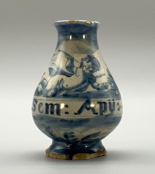 fig 2. Pair of 17th-century Italian Savona majolica apothecary bottles with cobalt blue hand-painted putti and Latin inscriptions over a tin-glazed ground.