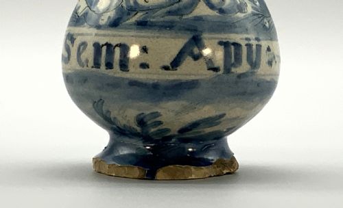 fig 4. Pair of 17th-century Italian Savona majolica apothecary bottles with cobalt blue hand-painted putti and Latin inscriptions over a tin-glazed ground.
