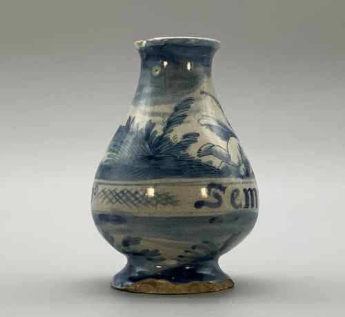 fig 5. Pair of 17th-century Italian Savona majolica apothecary bottles with cobalt blue hand-painted putti and Latin inscriptions over a tin-glazed ground.