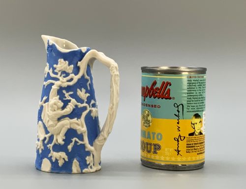 fig 1. A Victorian blue and white Parian ware jug featuring a textured cobalt blue ground with raised white relief figures climbing a tree and a moulded branch handle.