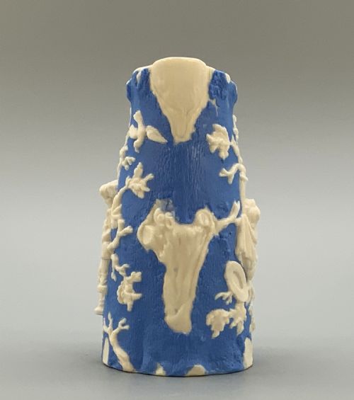 fig 4. A Victorian blue and white Parian ware jug featuring a textured cobalt blue ground with raised white relief figures climbing a tree and a moulded branch handle.