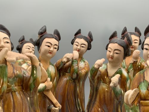 fig 7. A set of seven Tang dynasty style lead-glazed earthenware figurines depicting standing female court musicians holding traditional instruments.