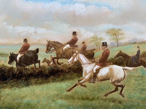 fig 2. An oil painting on board depicting horseback riders navigating a grassy field, housed in a decorative gilded frame.